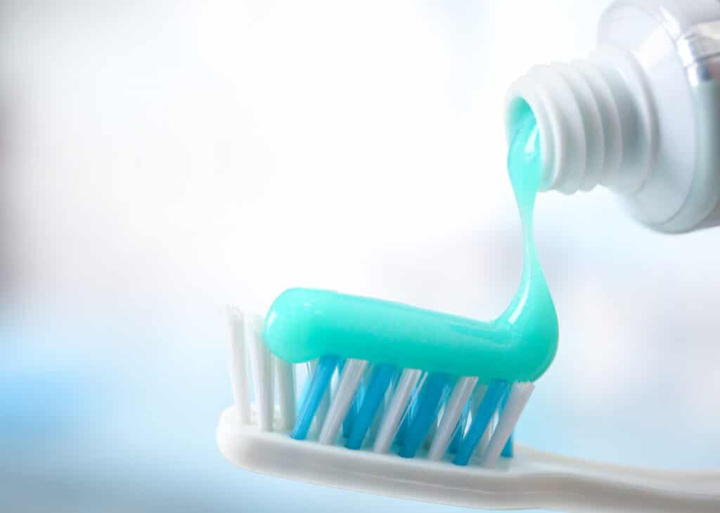 Toothbrush and toothpaste on blurred background. fluoride question